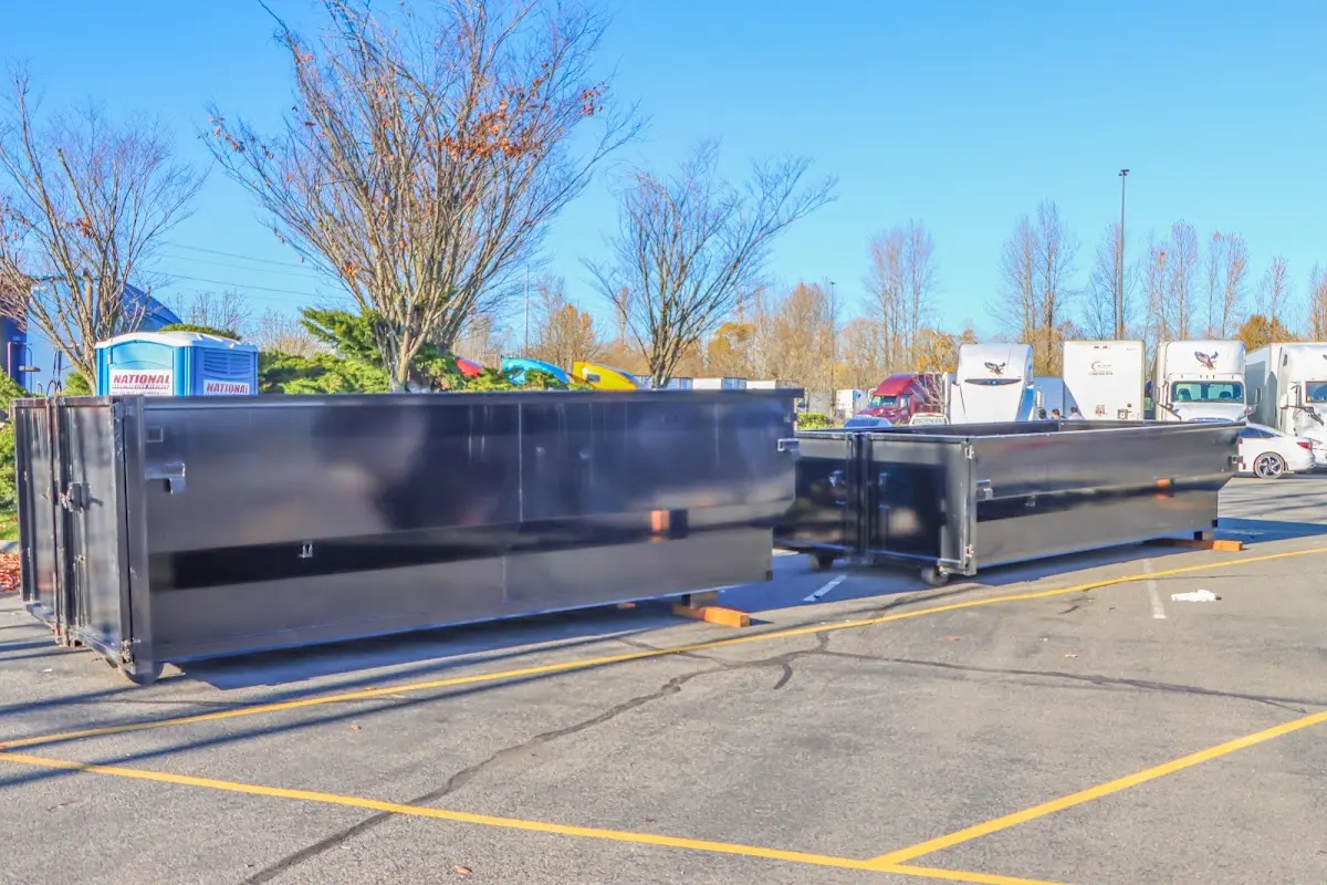 Professional dumpster rental service with roll-off container on residential driveway in Carterville